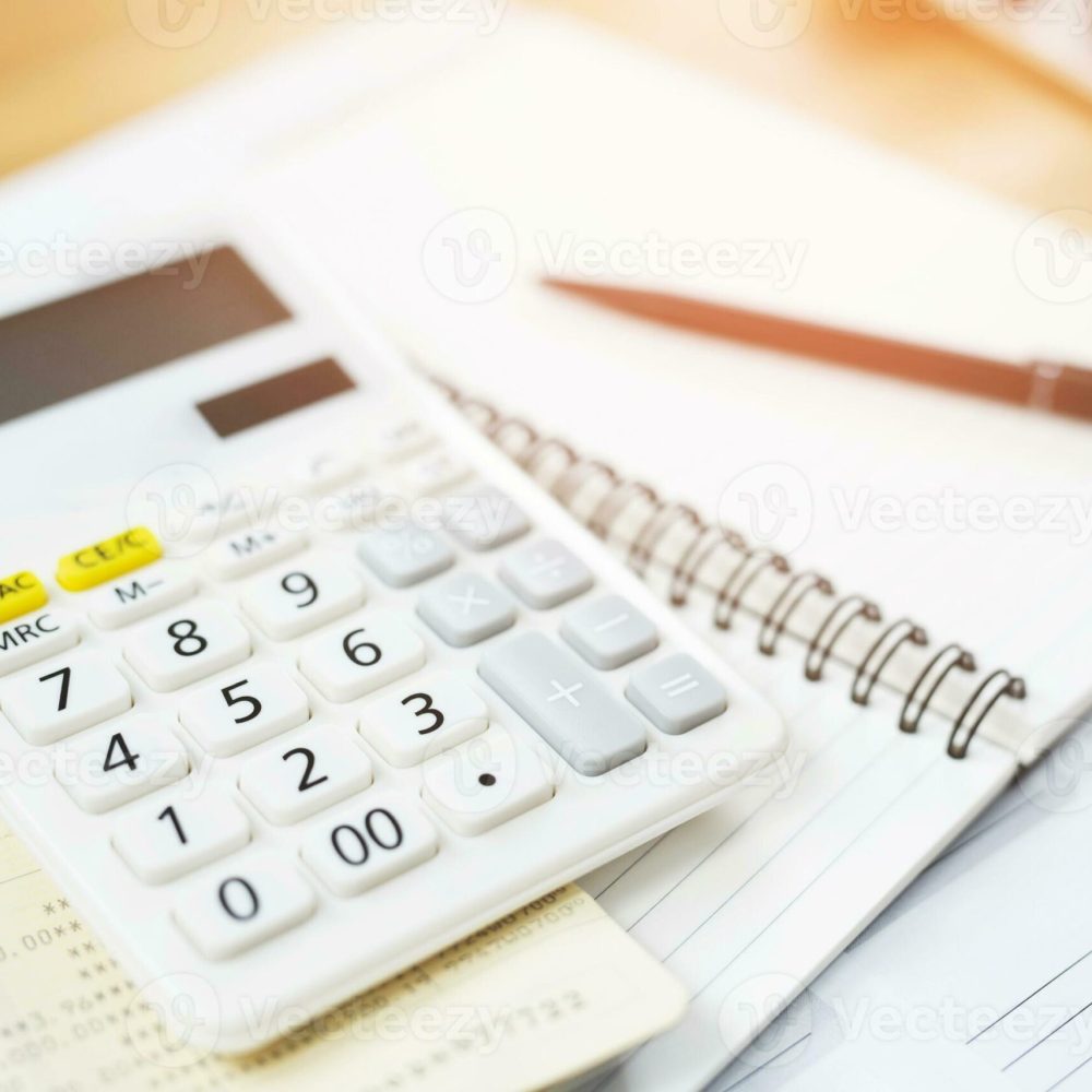 office-desk-table-calculator-with-notepad-book-and-black-pen-top-view-with-copy-space-investment-calculation-accounting-financial-concept-photo-scaled.jpeg